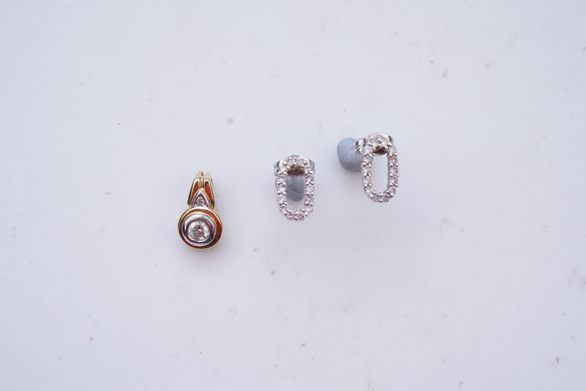 A diamond pendant and pair of diamond stud earrings